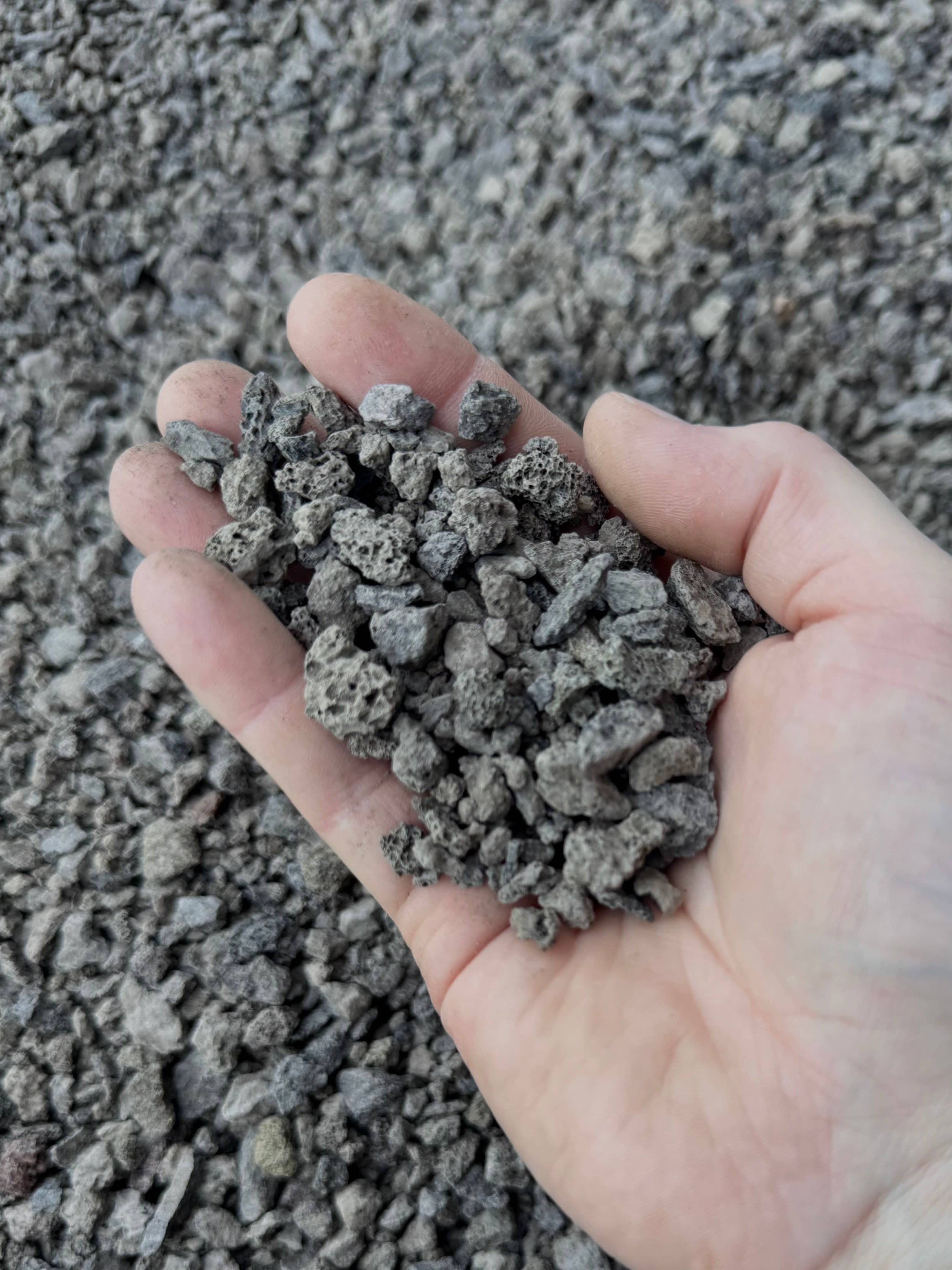 SMUKHI lava rock substrate showing porous black volcanic stones for aquariums or gardening, natural and textured appearance.