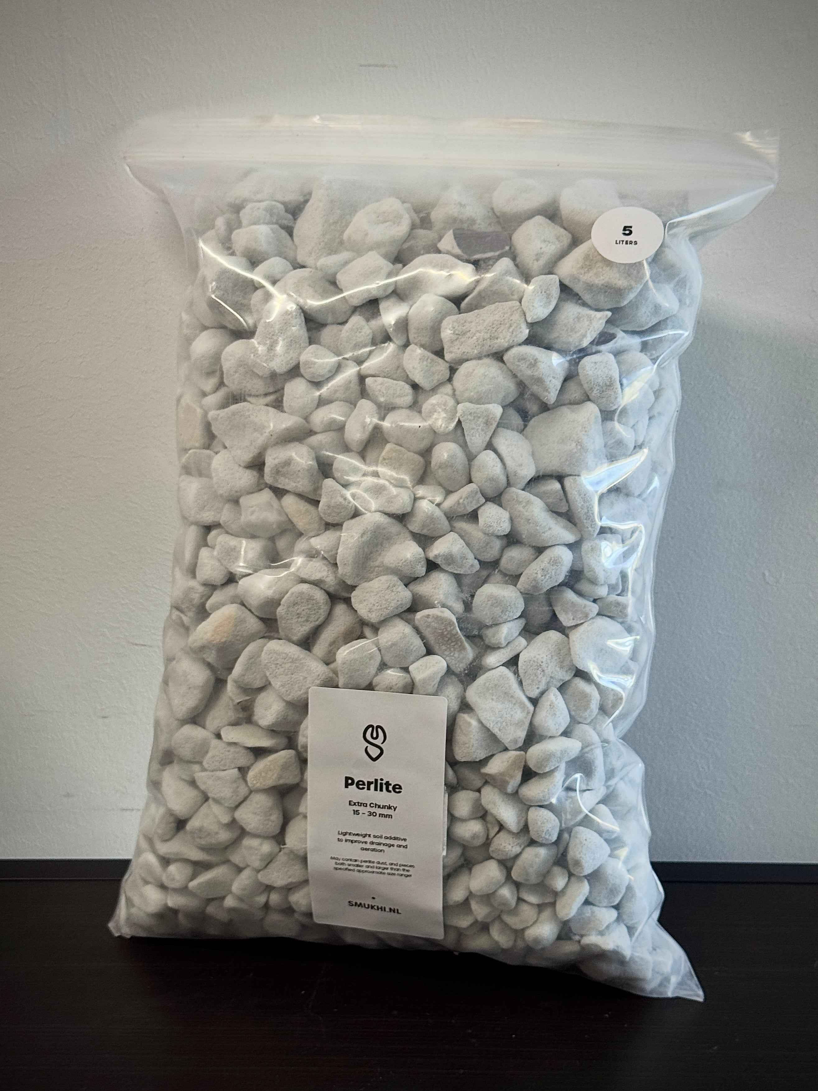Perlite substrate by SMUKHI, showing white expanded volcanic rock used for soil aeration and drainage in gardening.