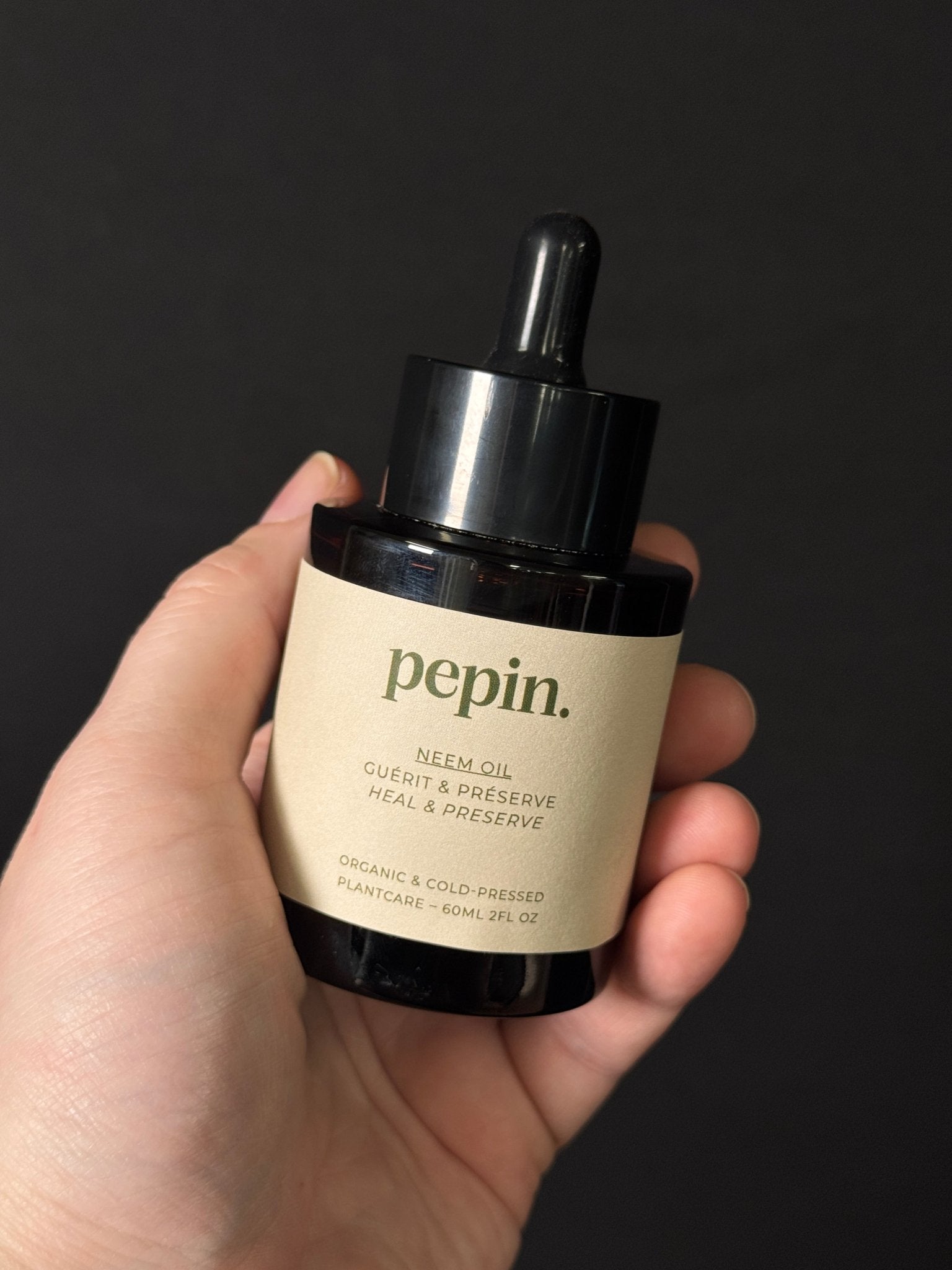 Virgin Neem Oil by PEPIN, natural insecticide for pest control, shown in a clear bottle with a green label.