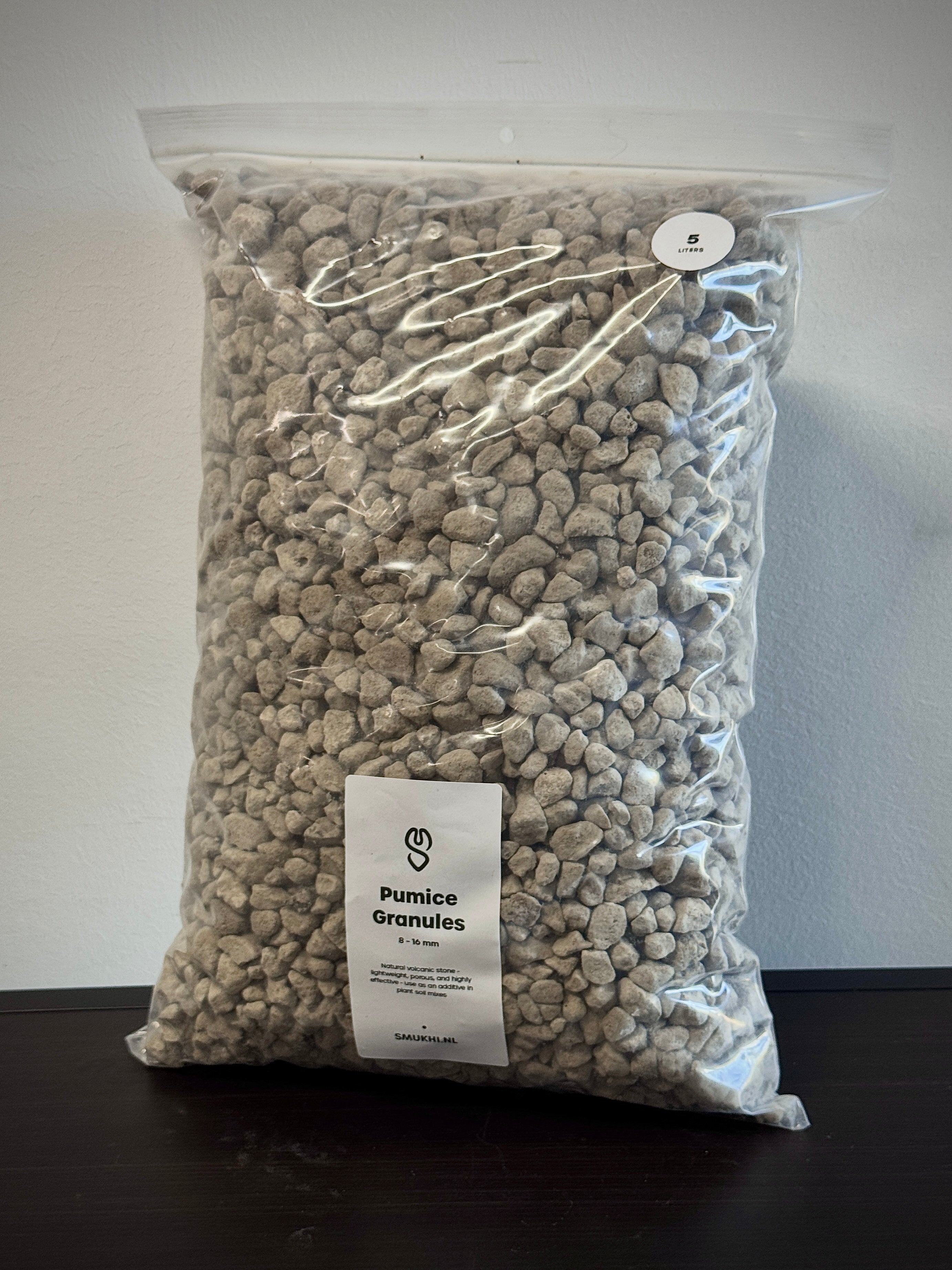 SMUKHI pumice substrate for gardening, showing light porous volcanic rock used to improve soil aeration and drainage.